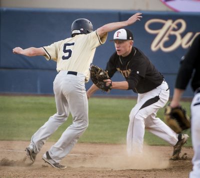 University’s Mitchell Rhodes, right, tags out Mead’s Evan Rice as he attempts to get back to first base during Thursday’s District 8 4A baseball play at Avista Stadium. (Colin Mulvany)