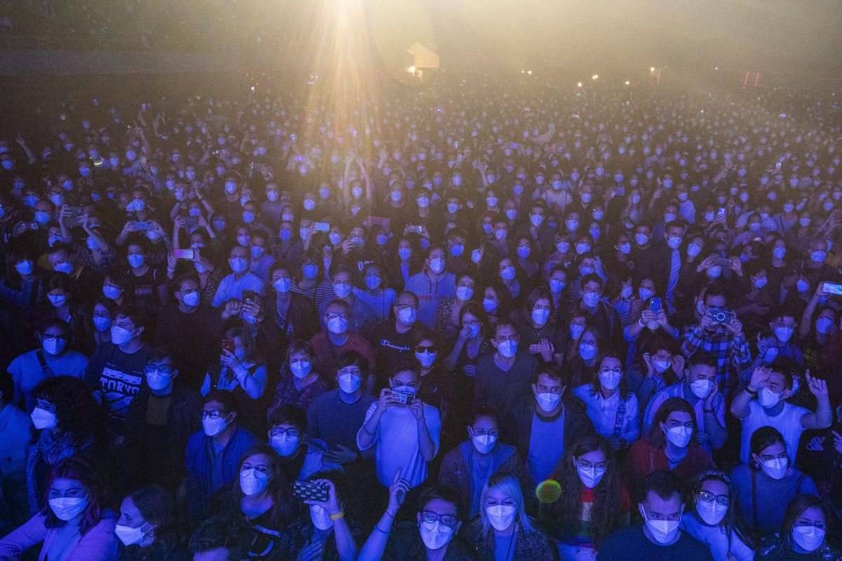 People using face masks take part in a music concert in Barcelona, Spain, Saturday, March 27, 2021. Five thousand music lovers are set to attend a rock concert in Barcelona on Saturday after passing a same-day COVID-19 screening to test its effectiveness in preventing outbreaks of the virus at large cultural events. The show by Spanish rock group Love of Lesbian has the special permission of Spanish health authorities. While the rest of the country is limited to gatherings of no more than four people in closed spaces, the concertgoers will be able to mix freely while wearing face masks. (Emilio Morenatti)