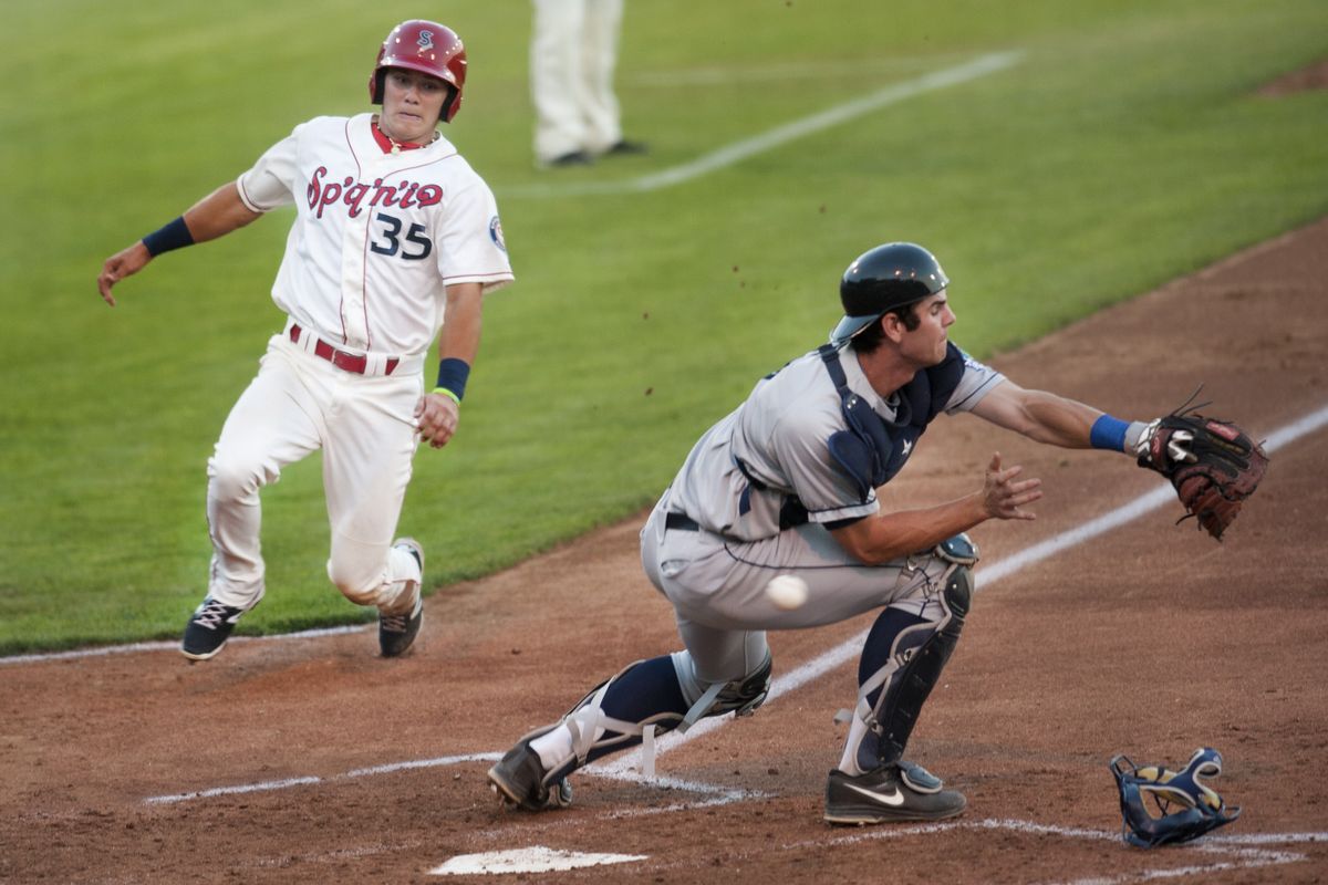 Spokane’s Jose Cardona comes into score during eight-run fourth inning with help from a wild throw by the AquaSox. (TYLER TJOMSLAND PHOTOS)