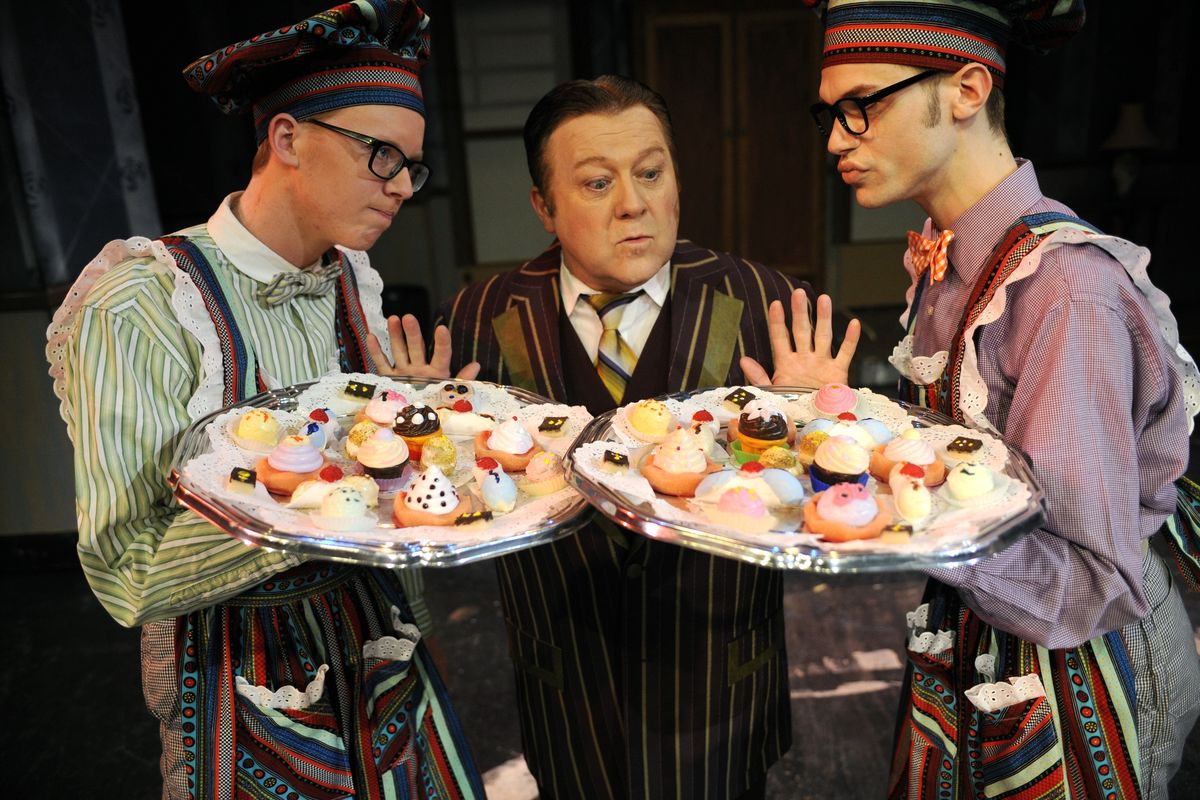 In a scene from Civic Theatre’s production of “The Drowsy Chaperone,” gangsters dressed as pastry chefs, played by Eric McGaughy, left, and Dustin Sorrell, right, threaten Mr. Feldzieg, played by Michael Hynes. The play opens tonight and runs through March 17. (Colin Mulvany)