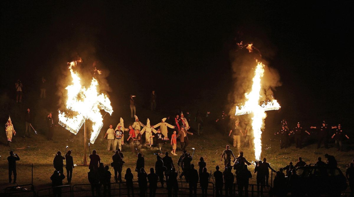 Members of the Ku Klux Klan participate in cross and swastika burnings after a "white pride" rally April 23, 2016, in rural Paulding County near Cedar Town, Ga. (Mike Stewart / AP)