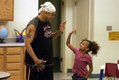 
Ricky Molina gets a high-five from his daughter Alyssa on Thursday, her first day  at the  Central Valley Kindergarten Center in the Central Valley School District. 
 (Dan Pelle / The Spokesman-Review)