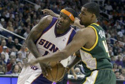 Phoenix Suns forward Amare Stoudemire, left, drives hard to the basket. Associated Press
(Associated Press / The Spokesman-Review)