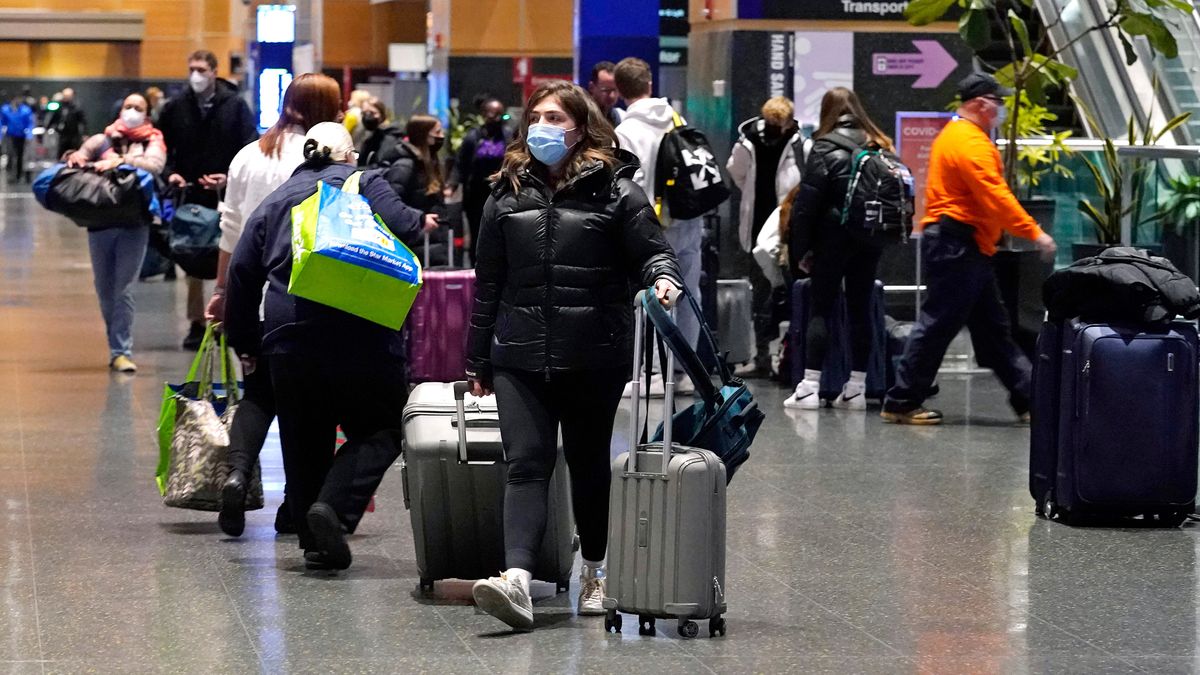 Travelers trek through Terminal E at Logan Airport on Tuesday in Boston.  (Charles Krupa/Associated Press)