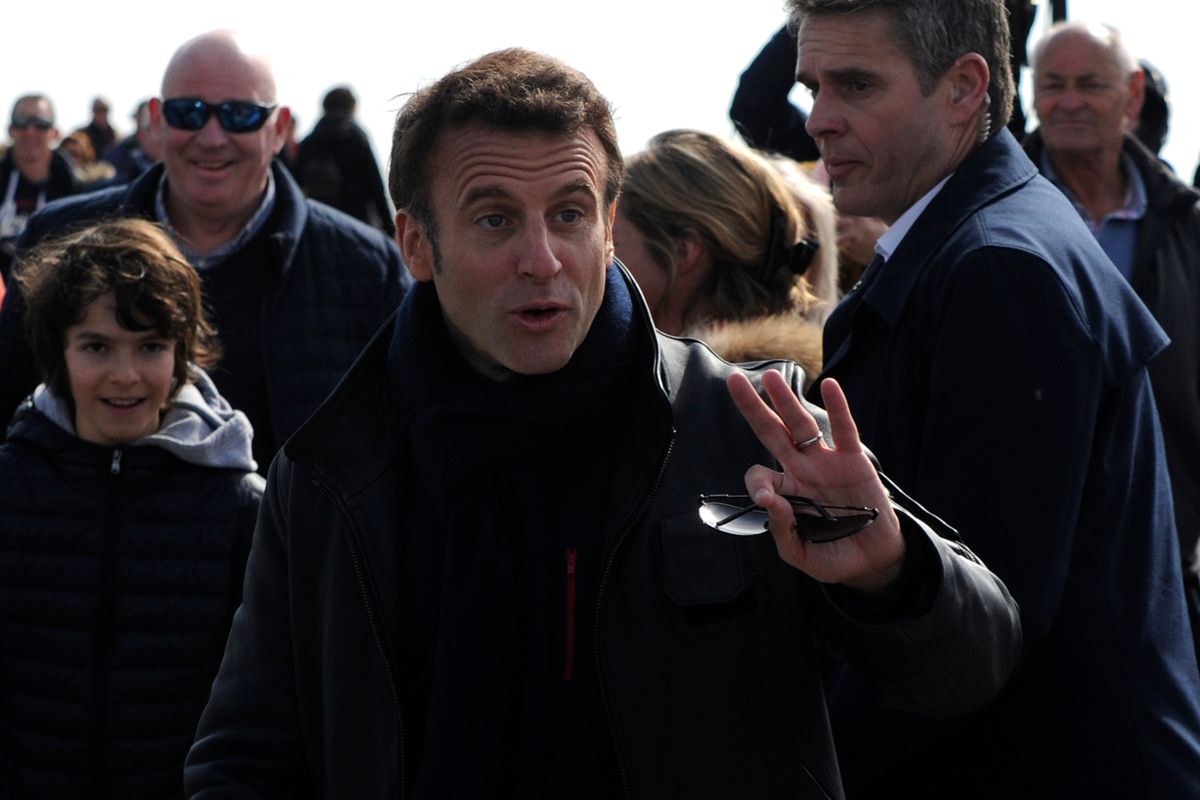 French President and centrist presidential candidate for re-election Emmanuel Macron gestures as he strolls after voting for the first round of the presidential election on Sunday in Le Touquet, northern France. (Louis Witter)
