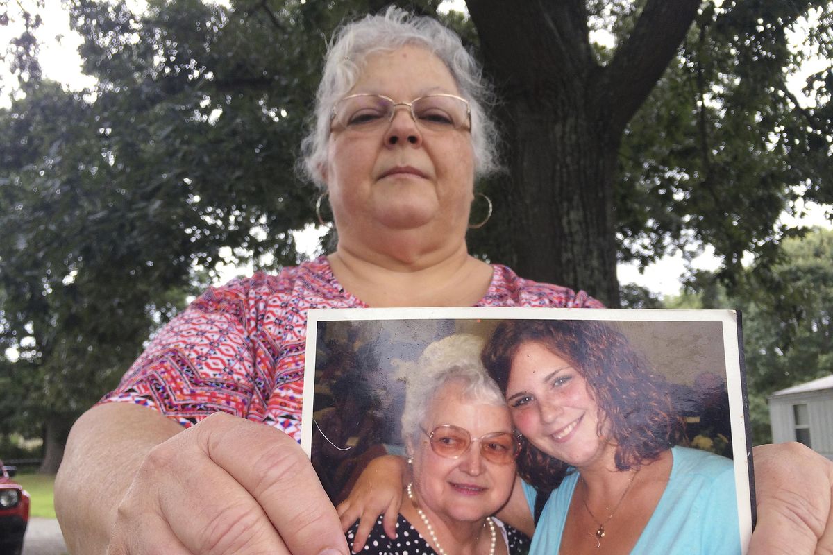 Susan Bro, the mother of Heather Heyer, holds a photo of Bro