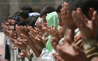 
Iraqi Shiite Muslims offer Friday prayers at the Imam Mousa al-Kadim shrine in Baghdad. Thousands of Shiites  are expected to gather today  to  commemorate the imam's death.
 (Associated Press / The Spokesman-Review)