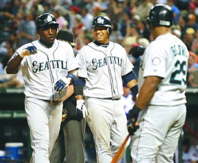 
Yuniesky Betancourt, Jose Lopez and Adrian Beltre, left to right, celebrate after scoring on an Ichiro Suzuki triple in the fourth inning. 
 (Associated Press / The Spokesman-Review)