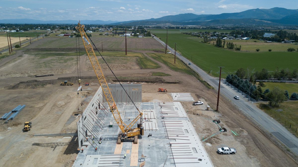 The tilt-up walls of the new Spokesman-Review printing plant and warehouse are set into place, Tuesday, July 9, 2019, at 19223 E. Euclid Avenue, Spokane Valley. The facility will house the printing press and serve as the warehouse for the newspaper. The current production facility will be repurposed for other commercial uses, including for Dry Fly Distillery. (Jesse Tinsley / The Spokesman-Review)