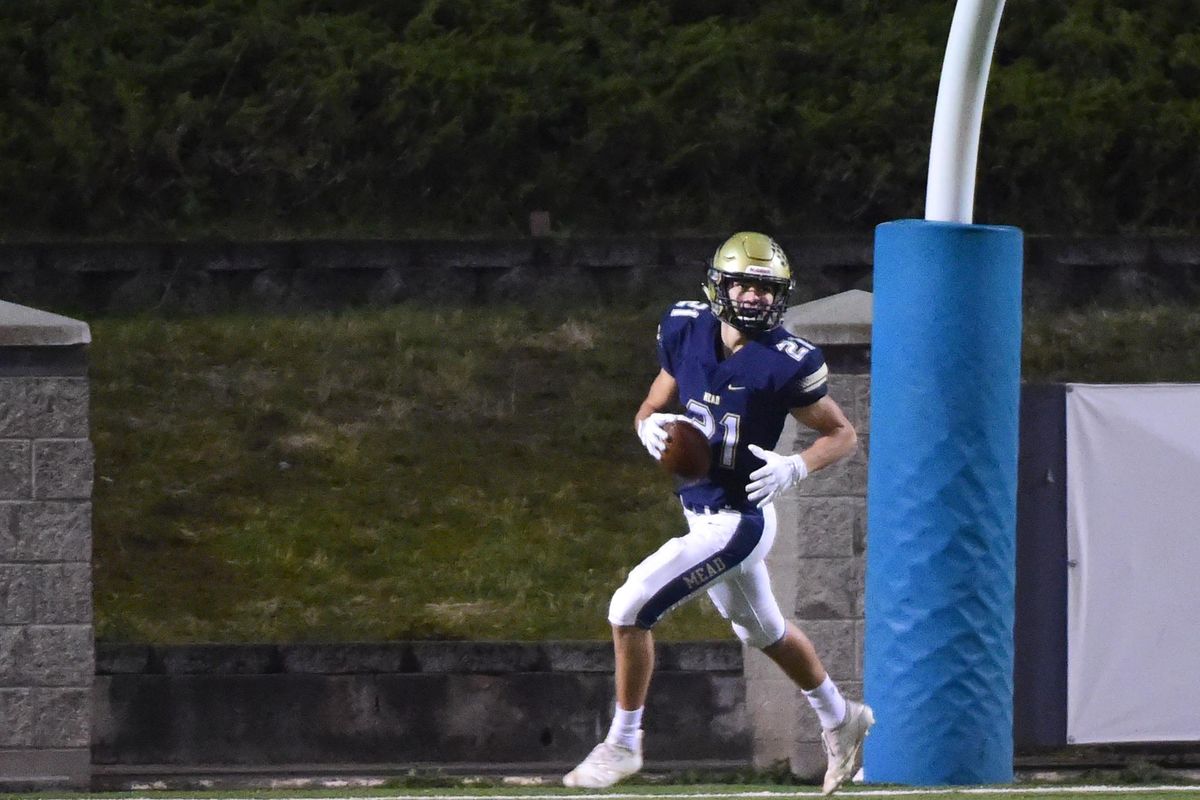 Mead’s Michael Workman trots into the end zone on a long pass and run to score against Lewis and Clark on Thursday  at Albi Stadium. (Jesse Tinsley / The Spokesman-Review)