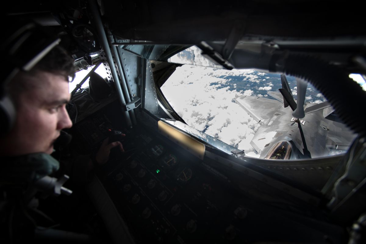 Airman First Class Riley Noel, left, lays in the boom operator’s position in a KC-135 refueling tanker plane and guides the refueling boom down to an F22 Raptor, the U.S. Air Force’s fastest and most advanced airplane, Thursday, June 20, 2019. Two of the planes were en route from Nellis Air Force Base to Spokane for Skyfest, the Fairchild Air Force Base air show on Saturday and got refueled on their way in. (Jesse Tinsley / The Spokesman-Review)