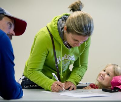 Addison Havel, 4, of Newman Lake, beams as her mother, Sherri Havel, registers to vote for the first time Monday at the Spokane County Elections Office. Monday was the last day to register to participate in the Nov. 6 general election. “It’s time to be part of the decision-making process. Can’t complain if I don’t vote,” Havel said. (Dan Pelle)