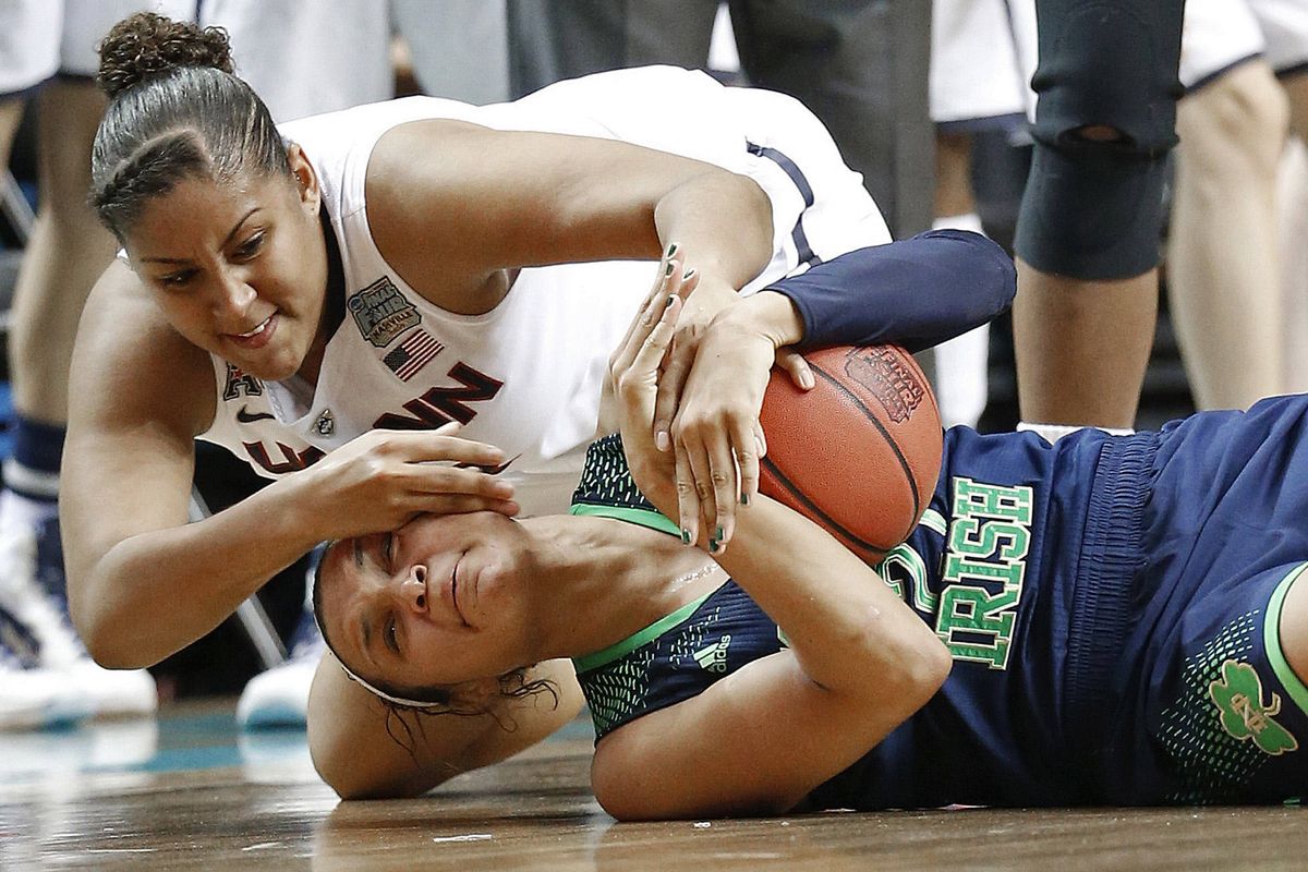 Connecticut’s Kaleena Mosqueda-Lewis, top, and Notre Dame’s Kayla McBride scramble for the ball on Tuesday. (Associated Press)