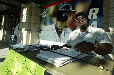 
David Jones appeals for signatures at a Mariners game at Seattle's Safeco Field. 
 (Associated Press / The Spokesman-Review)