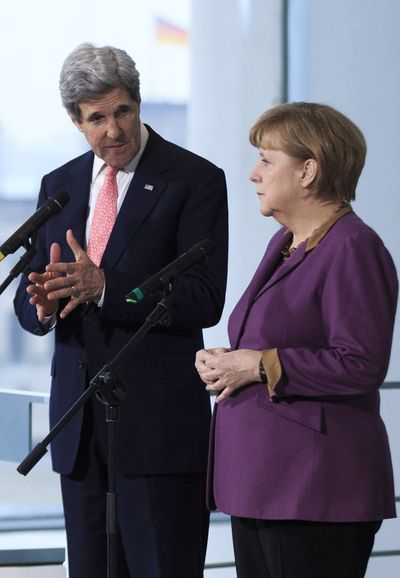 German Chancellor Angela Merkel and U.S. Secretary of State John Kerry speak in Berlin on Tuesday. (Associated Press)