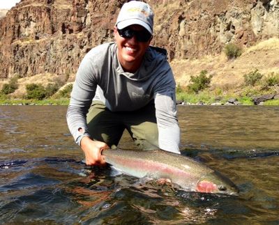 Fly fishing guide Sean Visintainer releases a steelhead caught in the Grande Ronde River on Sept. 17, 2014. (Courtesy)