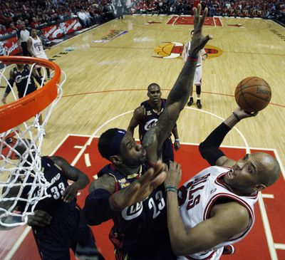 Taj Gibson, right, and the Chicago Bulls avoided a 3-0 series hole to LeBron James and the Cleveland Cavaliers, winning 108-106.  (Associated Press)