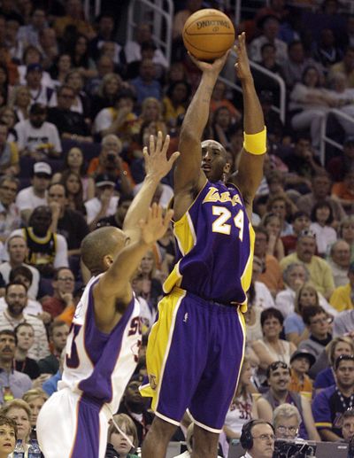 A 49-point performance by Lakers guard Kobe Bryant, shooting over Phoenix’s Grant Hill in the third quarter, wasn’t enough to beat the Suns.  (Associated Press / The Spokesman-Review)