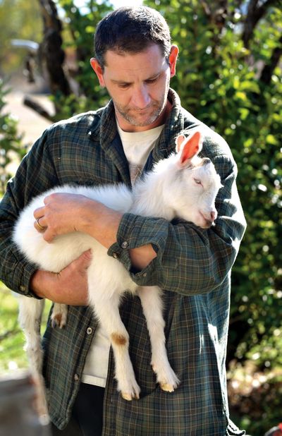 Earl Akers holds his pet goat Rocket, in White City, Ore., on Thursday. Akers hopes that Jackson County will change its regulations about keeping farm animals in White City so he can keep Rocket. (Associated Press)