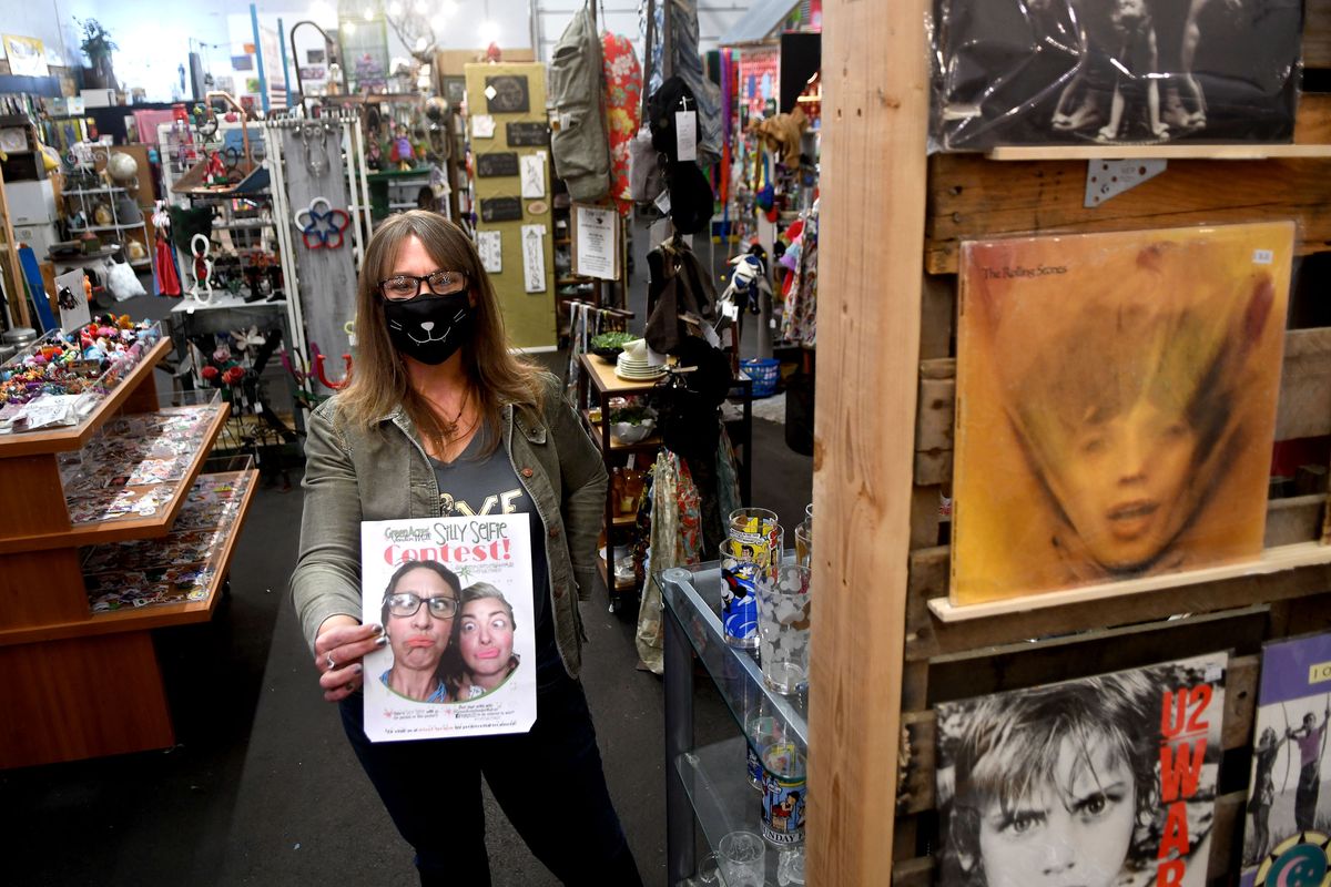 Greenacres Vendor Mall owner Genesis Finley holds a selfie taken with co-owner Carla Klauder on Thursday, Nov. 19, 2020.  (Kathy Plonka/The Spokesman-Review)