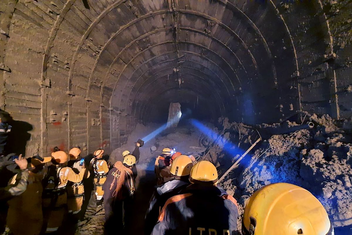 This photograph provided by Indo Tibetan Border Police (ITBP) shows ITBP personnel use torches to gain access inside a tunnel to rescue more than three dozen power plant workers trapped inside it after part of a Himalayan glacier broke off Sunday and sent a wall of water and debris rushing down the mountain in Tapovan area of the northern state of Uttarakhand, India, Tuesday, Feb. 9, 2021. Hundreds of rescue workers were scouring muck-filled ravines and valleys in northern India on Tuesday looking for survivors after part of a Himalayan glacier broke off, unleashing a devastating flood that has left at least 31 people dead and 165 missing.  (HONS)