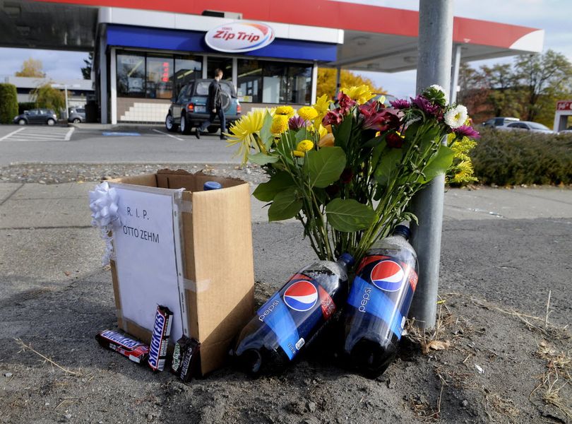 Snickers candy bars, flowers and 2 liter bottles of Pepsi Cola are left curb-side, Nov. 4, 2011 in front of the Zip Trip, on Division at Augusta, where Otto Zehm was beaten unconscious by Spokane police officers, in March 2006, who thought Zehm was a robbery suspect. Zehm died 2 days later.  (Dan Pelle / The Spokesman-Review)