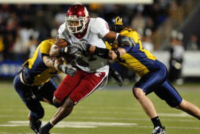
California's Anthony Felder, left, and Chris Conte tackle Washington State's Brandon Gibson during Saturday night's game. 
 (Kevin Nibur Special to / The Spokesman-Review)