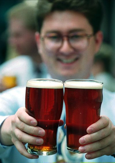 Steve Langden sits behind two pints of British Best bitter in a London pub. British pubs are closing down faster than a thirsty drinker can down a pint. (File Associated Press / The Spokesman-Review)