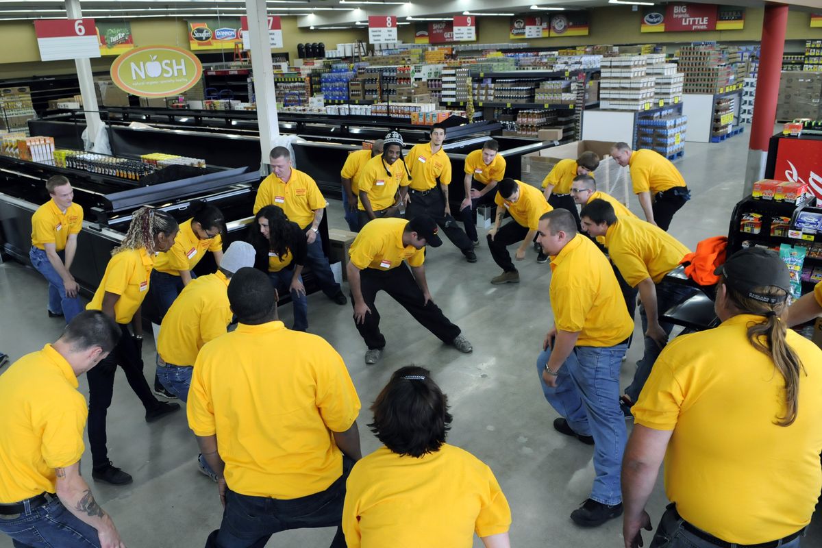 Grocery Outlet employees gather for group stretching during training sessions at the Third and Maple location.