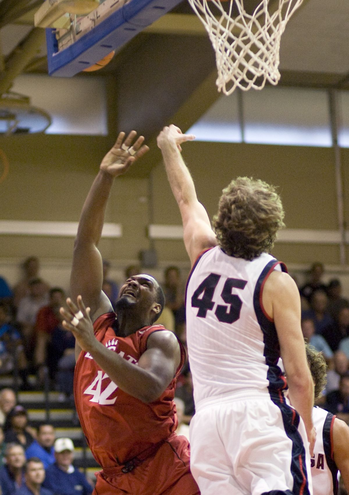 Cincinnati’s Steve Toyloy has his shot blocked by GU’s Will Foster in the first half of title game.  (Associated Press)