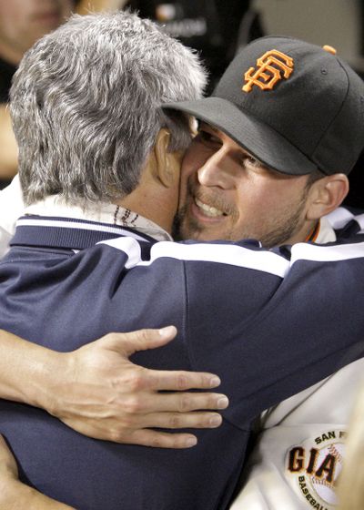 Jonathan Sanchez hugs his father after Friday’s no-hitter.  (Associated Press / The Spokesman-Review)