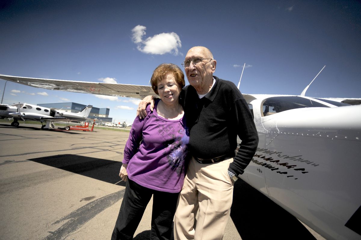 Myrl Hoefer, who flew himself around the country as a traveling salesman for many years but stopped flying in 1988, smiles and hugs Jaynie Stephenson after returning from a flight with an instructor at Spokane International Airport on Tuesday. (Jesse Tinsley)