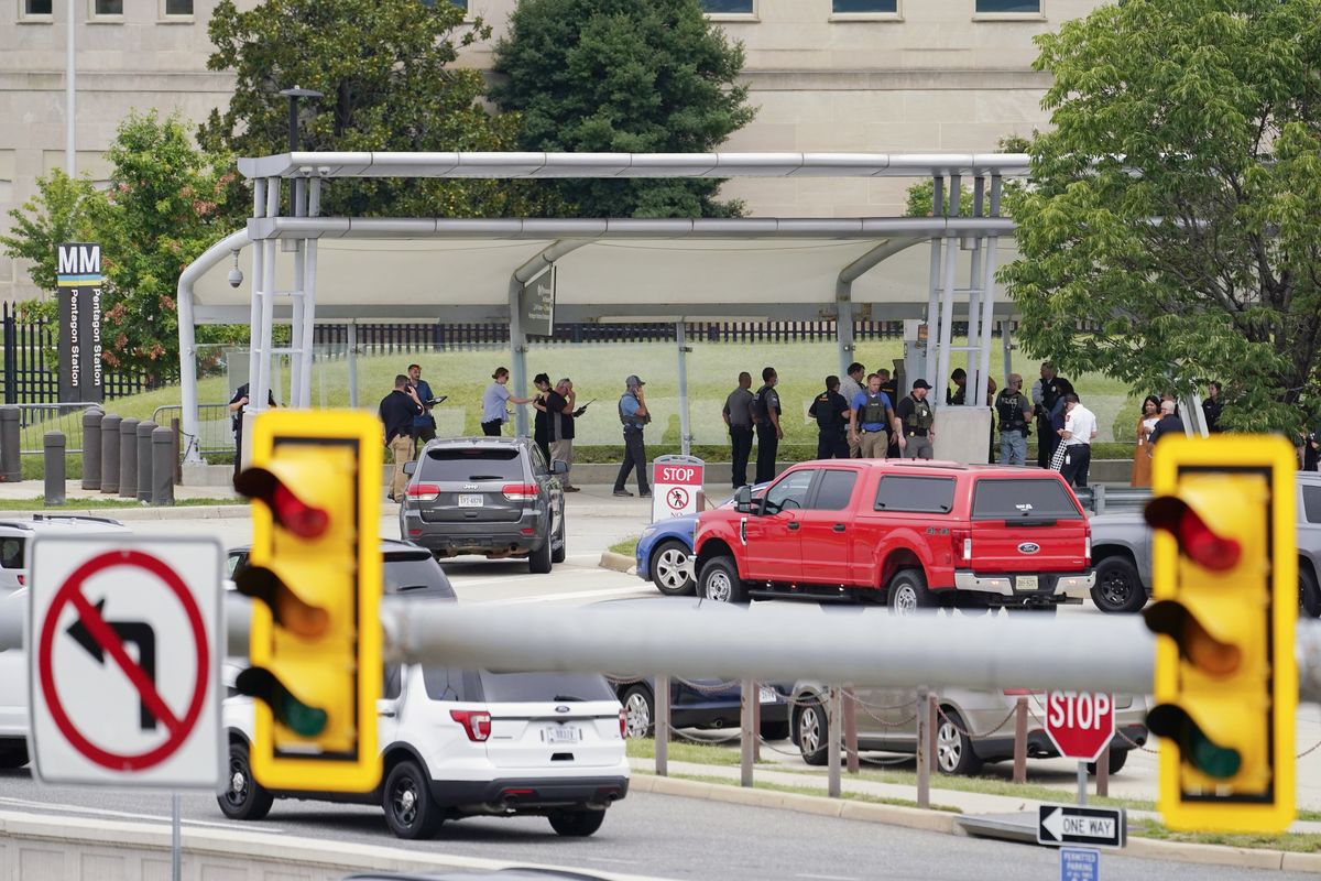 Police vehicles are seen outside the Pentagon Metro area Tuesday, Aug. 3, 2021, at the Pentagon in Washington. The Pentagon is on lockdown after multiple gunshots were fired near a platform by the facility