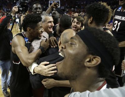 South Carolina head coach Frank Martin and his Gamecocks enjoy their second-round win over Duke to advance to their first Sweet 16. (Chuck Burton / Associated Press)