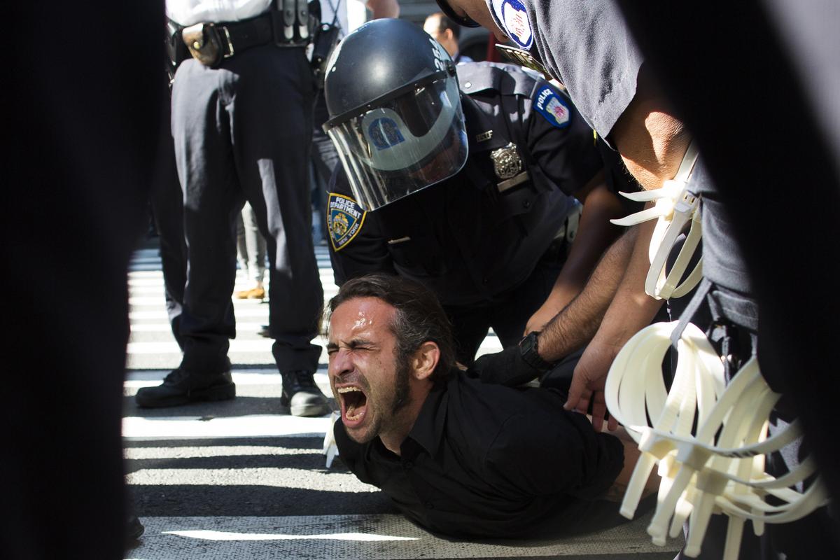 Occupy Wall Street protestor Chris Philips screams as he is arrested near Zuccotti Park, Monday, Sept. 17, 2012, in New York. Multiple Occupy Wall Street protestors have been arrested during a march toward the New York Stock Exchange on the anniversary of the grass-roots movement. (John Minchillo / Fr170537 Ap)