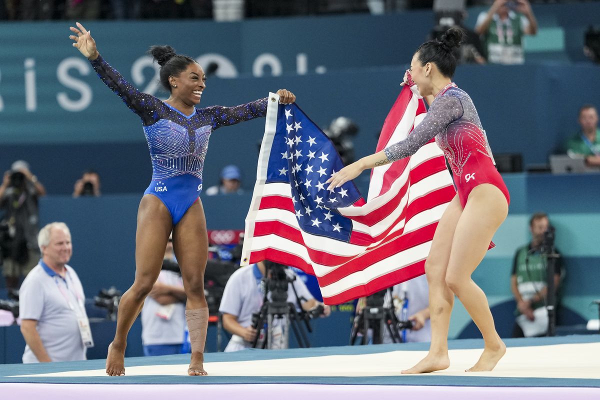 From left: Simone Biles and Sunisa Lee of the U.S. celebrate after the artistic gymnastics women