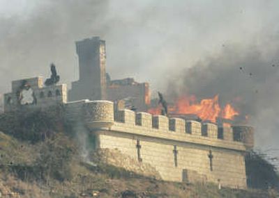 
Fire driven by strong Santa Ana winds consumes a castle in Malibu, Calif.,  on Sunday. Associated Press
 (Associated Press / The Spokesman-Review)