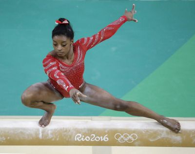 U.S. gymnastics star Simone Biles, who has won the last three world all-around championships, trains on the balance beam. (Julio Cortez / Associated Press)