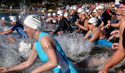 
The first of more than 500 competitors dash into the water at the Valley Girl Triathlon in Liberty Lake on Sunday. 
 (Liz Kishimoto / The Spokesman-Review)