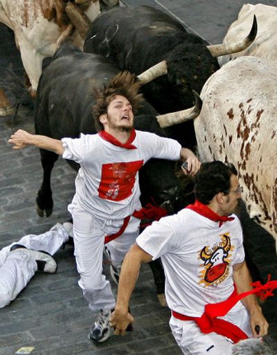 
A man is gored by a bull Friday during the first run of the famous San Fermin festival in Pamplona, Spain. The San Fermin festival dates to the late 16th century.
 (Associated Press / The Spokesman-Review)