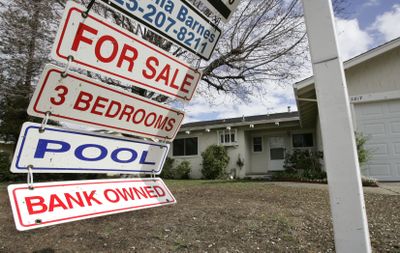 A foreclosure sign blows in the wind in front of a home under foreclosure in February in Antioch, Calif. Investors and first-time buyers continue to drive home sales in the West, according to two reports released Wednesday. (File Associated Press / The Spokesman-Review)