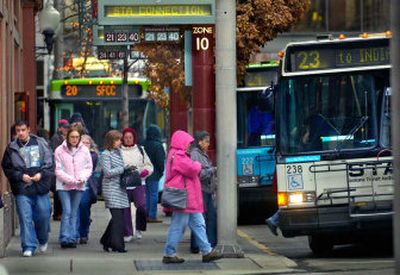
Buses drop passengers off at the west end of the STA Plaza on Thursday and prepare for another run. Because of increased ridership on some routes, STA will buy 40-foot buses now, though the board had pledged to buy smaller buses when campaigning for the sales tax increase that was approved in 2004.
 (Christopher Anderson/ / The Spokesman-Review)