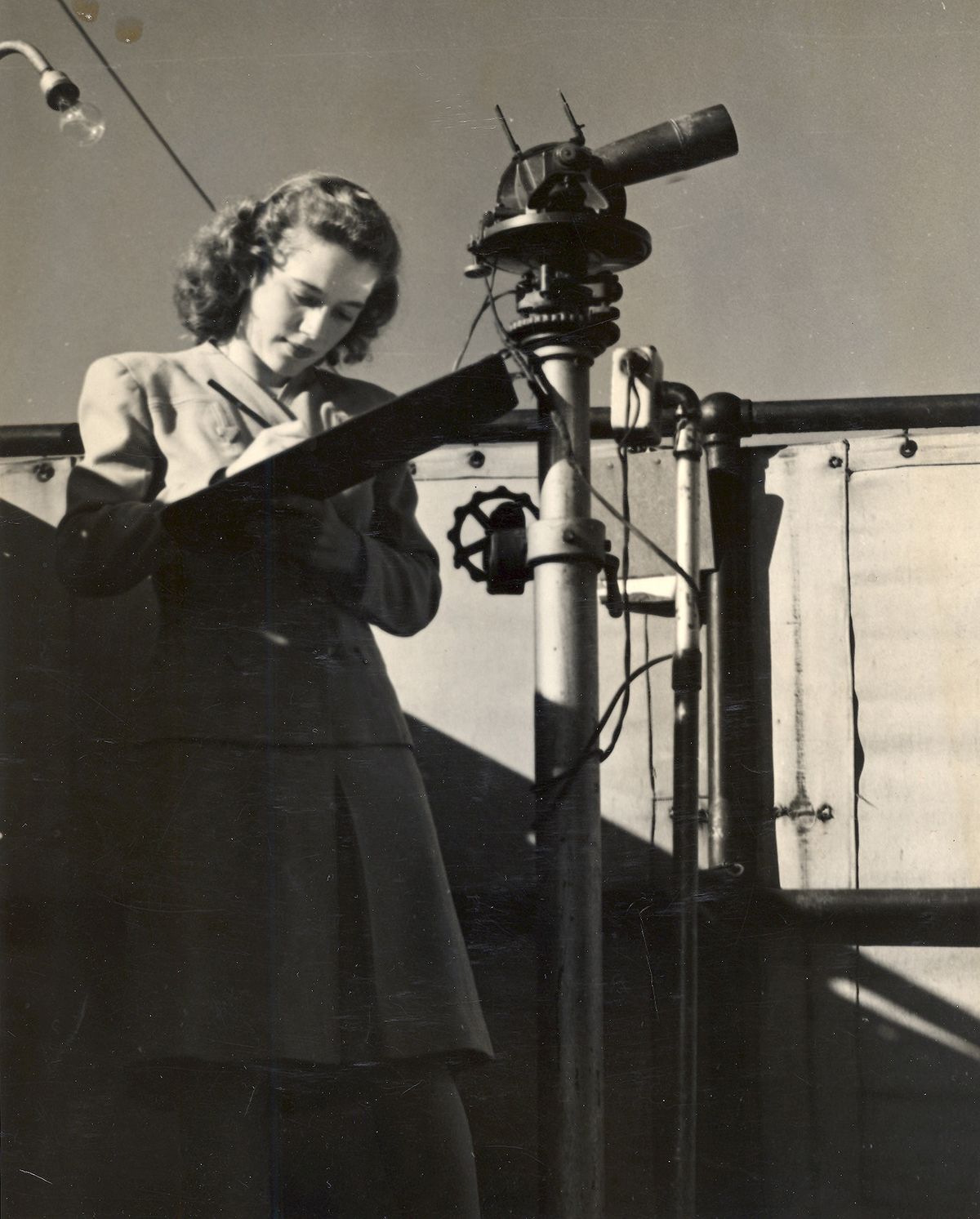Evelyn Conant, war appointment weather observer, records information, in 1944, from a theodolite at Felts Field. Photo courtesy of Evelyn Conant (Photo courtesy of Evelyn Conant / The Spokesman-Review)