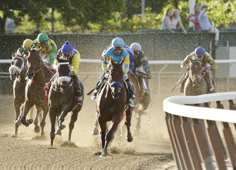 American Pharoah, with Victor Espinoza aboard, rounds the fourth turn ahead of the field at the 147th running of the Belmont Stakes. (Associated Press)