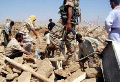 
Men search through rubble for survivors and bodies Wednesday after a coordinated suicide attack Tuesday in  two villages near Qahataniya in northern Iraq. Officials have confirmed 250 people were killed but say that number could reach 500. Associated Press
 (Associated Press / The Spokesman-Review)