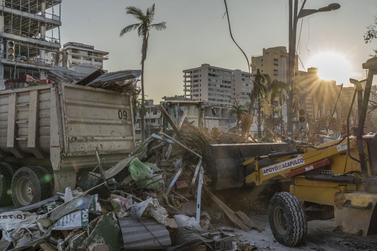 Above: Construction workers clean up debris in the aftermath of Hurricane Otis in Mexico. Left: U.S. climate envoy John Kerry, right, speaks with his Chinese counterpart, Xie Zhenhua, at COP28 in Dubai, United Arab Emirates.  (Alejandro Cegarra/Bloomberg)