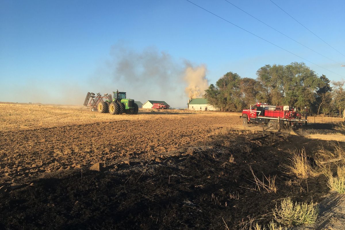 A fire burns Sunday evening in the Deep Creek area northwest of Spokane. Fire officials say six structures have burned.  (Kip Hill/Spokesman-Review)