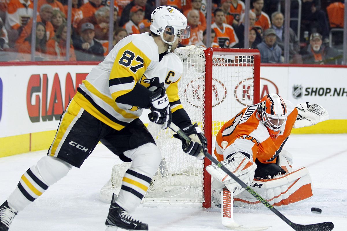 Pittsburgh Penguins’ Sidney Crosby, left, tries for a goal as Philadelphia Flyers’ Brian Elliott defends during the first period in Game 4 of an NHL first-round hockey playoff series Wednesday, April 18, 2018, in Philadelphia. The Penguins won 5-0. (Tom Mihalek / Associated Press)
