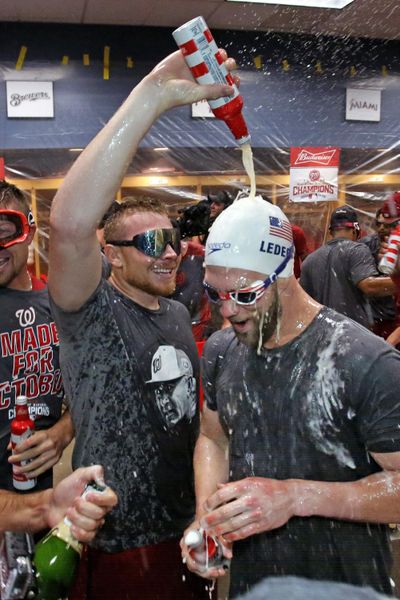 Washington Nationals' Bryce Harper, right, and Mark Melancon celebrate after clinching the National League East following a 6-1 win over the host Pittsburgh Pirates on Saturday. (Gene J. Puskar / Associated Press)