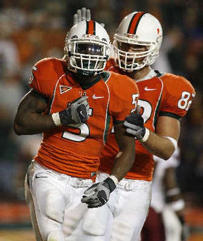 
Miami's Javarris James, front, celebrates a touchdown run. 
 (Associated Press / The Spokesman-Review)